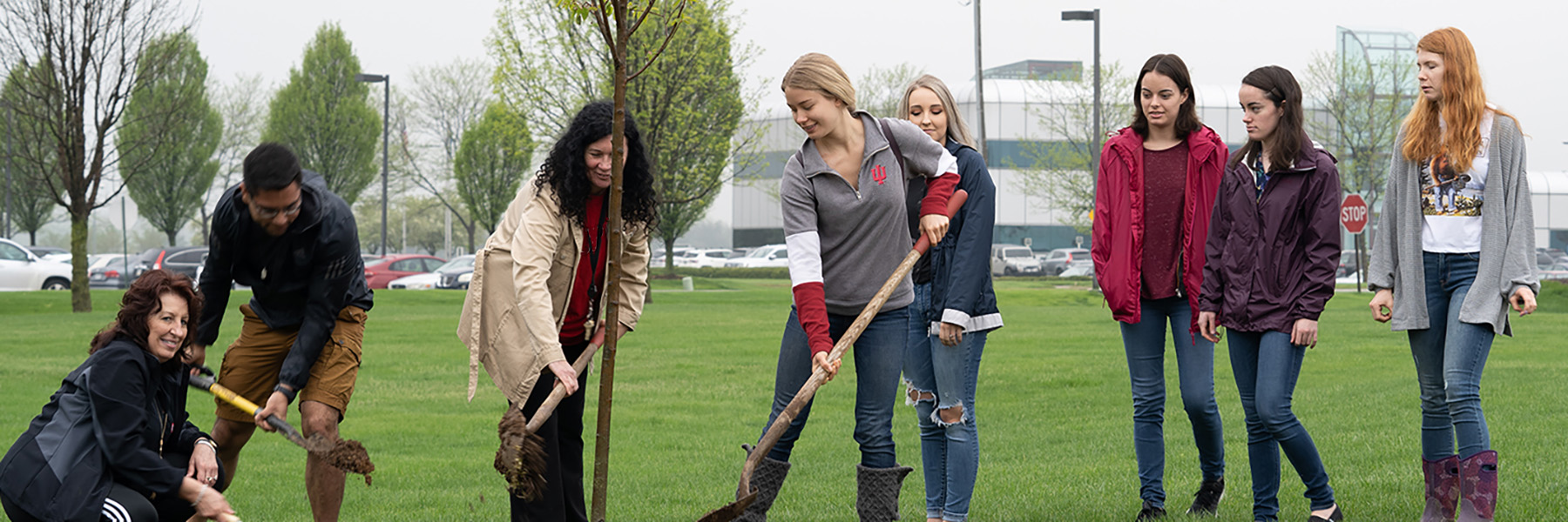 photo of students and faculty planting trees on campus.